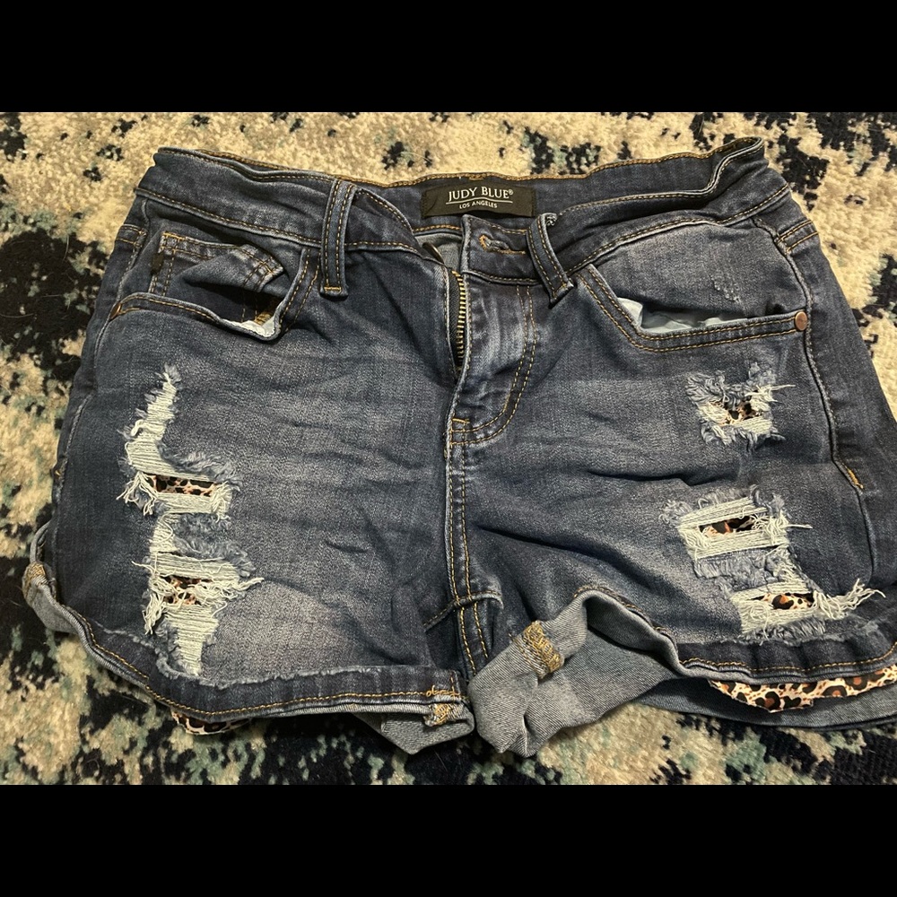 Distressed shorts size small with printed patches.